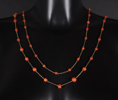 an orange beaded necklace on a mannequin mannequin mannequin mannequin mannequin mannequin mannequin mannequin mann