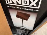 a cardboard box with a picture of a music stand inside of it