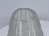a clear plastic cup sitting on top of a white table