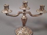 a silver candelab with three candles on it