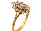 an image of a gold ring with a cluster of white diamonds