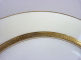 a close up of a plate with a gold edge