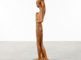 a wooden statue of a woman holding a baby in her arms