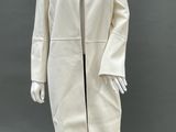 a mannequin wearing a white coat and black tights
