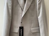 the jacket is hanging on a hanger on the wall