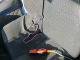 a car seat with a cord attached to the back of it
