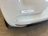 the rear end of a white car with a sticker on it ' s bumper