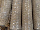 many rolls of wire wrapped in plastic on the ground