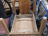 a wooden chair that is sitting next to a bicycle