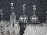 many glasses and decanters sitting on a table