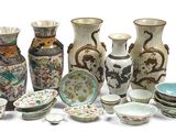 many vases and bowls that are sitting on a table