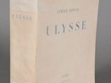 an old book sitting on top of a table on a gray surface