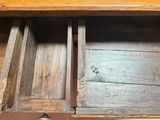 a wooden drawer with two open drawers on it