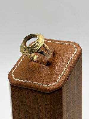 a wooden box with a ring on top of it