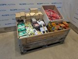 a wooden box filled with assorted items in front of a wall
