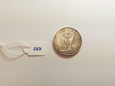 a close up of a coin on a white surface with a price tag