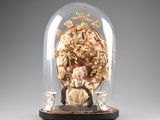 a glass dome with a figurine inside of it