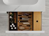 a bathroom sink with a lot of makeup and brushes in it