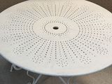 a white table that has a hole in it