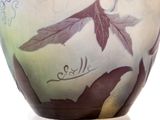 an image of a vase with leaves and birds painted on it