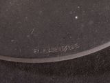 a black plate with a silver handle on a table