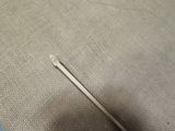 a needle that has been placed on a piece of fabric
