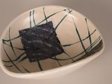 a small bowl with a piece of seaweed in it
