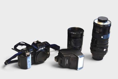 three cameras that are sitting next to each other on a table