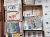 many boxes of mail sitting on the floor in a room