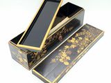 a black and gold box with a mirror inside of it