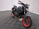 a black and red motorcycle parked on a black and white checkered floor