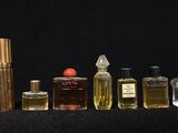 several different types of perfume bottles lined up on a black surface