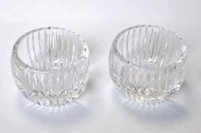 two clear glass bowls sitting on top of a white surface