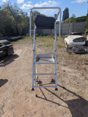 a ladder that is sitting on the ground in the dirt