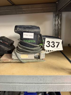 a sander on a shelf with a number on it