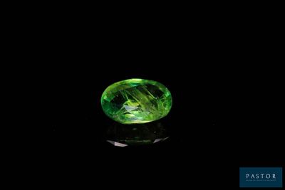 a green tourmaline gems on a black background