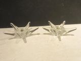 pair of clear glass starbursts on a white table