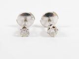 a pair of diamond stud earrings on a white background