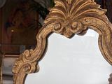 a person holding a mirror in their hand in a living room
