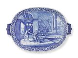 une assiette ovale bleue et blanche sur laquelle est représenté un homme et un chien