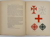 an open book with a picture of a cross and other symbols on it