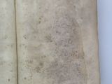an open book with a blank page sitting on top of a white table