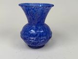 a blue vase that is sitting on a table