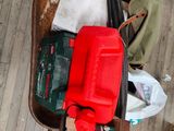 a red container sitting on top of a wheelbarrower