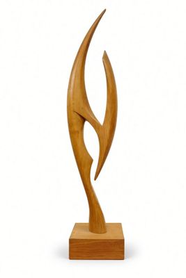 wooden sculpture of an abstract shape on a wooden base