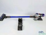 a close up of a cordless vacuum with a blue handle