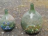 two vases sitting on the ground next to each other