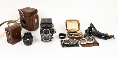 a lot of different types of old cameras on the table
