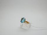 an image of a ring with a blue topaz stone in it