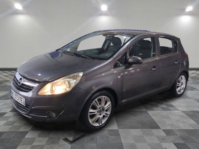 the grey car is parked in the garage on a checkered floor